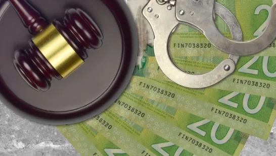 20 dollar notes with handcuffs and gavel fo counterfeit criminal activities